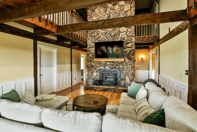 1416 Taylor Wood Rd, Simpsonville, KY 40067 - living room with a wood stove, beam ceiling, wainscoting, and wood finished floors