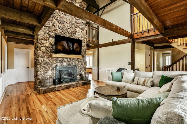 1416 Taylor Wood Rd, Simpsonville, KY 40067 - living area featuring stairway, wood finished floors, a wooden ceiling with exposed beams, a wood stove, and wainscoting