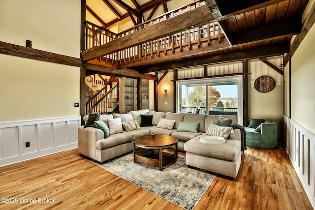 1416 Taylor Wood Rd, Simpsonville, KY 40067 - living area with stairs, wood finished floors, wainscoting, beam ceiling, and a towering ceiling