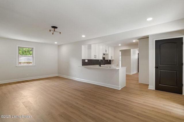 4205 Cottagehill Rd, Louisville, KY 40299 - unfurnished living room with light wood-type flooring, recessed lighting, a sink, and baseboards