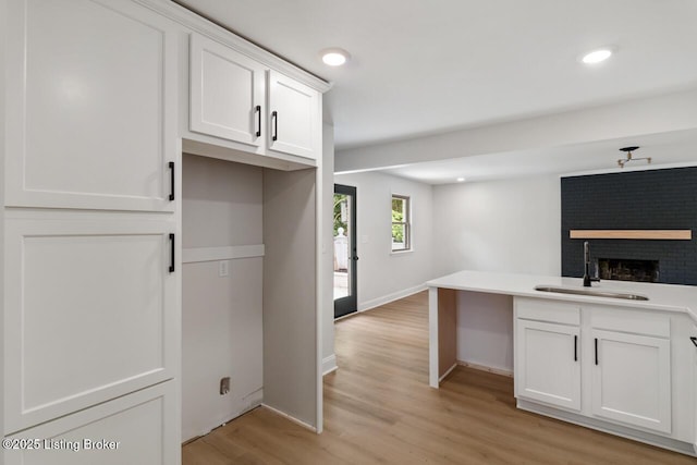 4205 Cottagehill Rd, Louisville, KY 40299 - kitchen with a sink, open floor plan, a fireplace, baseboards, and light wood-type flooring
