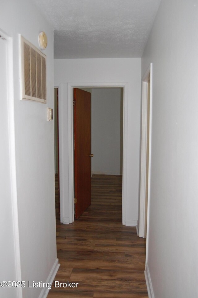 9530 Maple Rd, Louisville, KY 40229 - hall with dark wood-style floors and baseboards