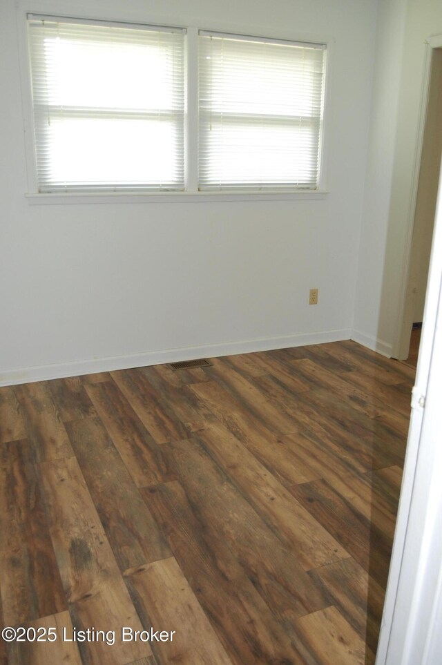 9530 Maple Rd, Louisville, KY 40229 - spare room featuring dark wood-style floors, plenty of natural light, and baseboards