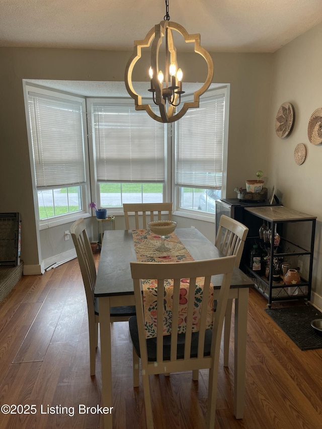 2623 Parklawn Dr, Louisville, KY 40217 - dining space with a chandelier, healthy amount of natural light, wood finished floors, and baseboards