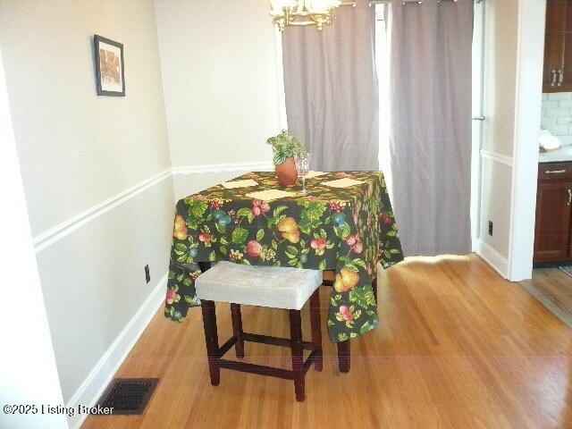 1411 Falcon Dr, Louisville, KY 40213 - sitting room with wood finished floors, a chandelier, and baseboards