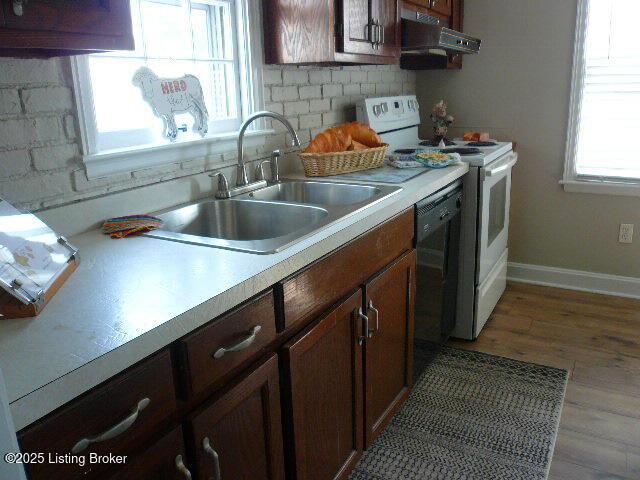 1411 Falcon Dr, Louisville, KY 40213 - kitchen featuring under cabinet range hood, white electric range, a sink, light countertops, and light wood-style floors