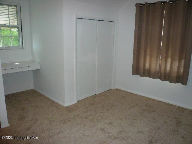 1411 Falcon Dr, Louisville, KY 40213 - unfurnished bedroom with carpet floors, a closet, and baseboards
