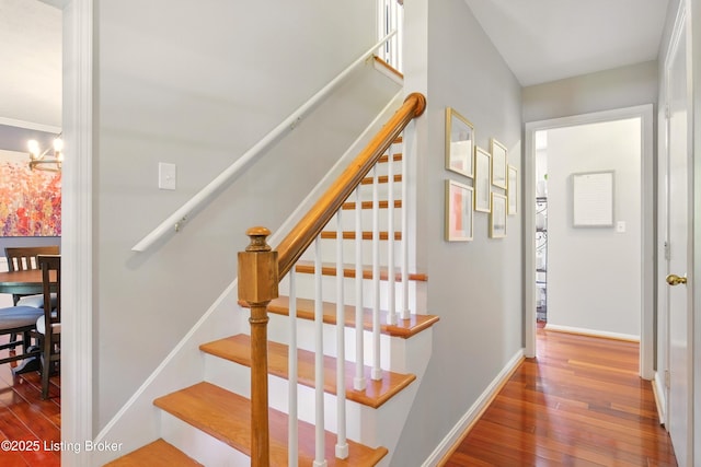 828 Dorsey Ln, Louisville, KY 40223 - staircase featuring wood-type flooring, a chandelier, and baseboards