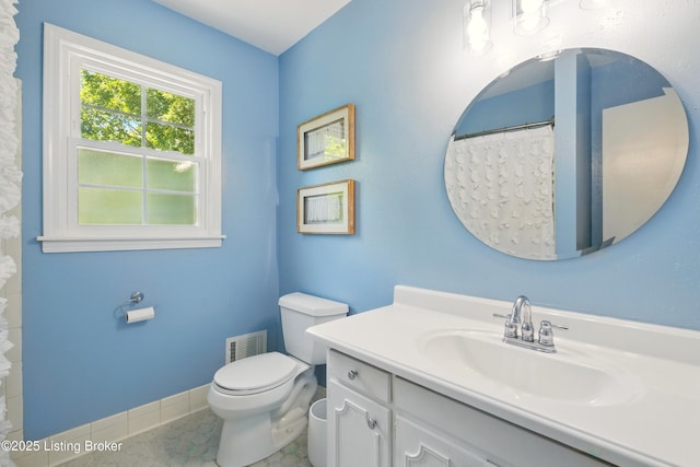 828 Dorsey Ln, Louisville, KY 40223 - bathroom with vanity, toilet, tile patterned floors, and baseboards