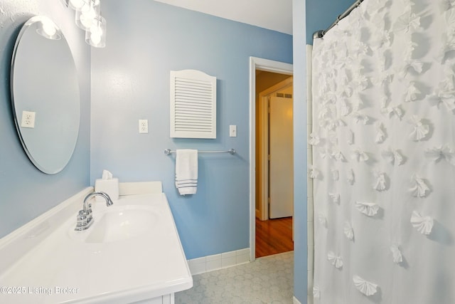 828 Dorsey Ln, Louisville, KY 40223 - bathroom with vanity, baseboards, and a shower with shower curtain