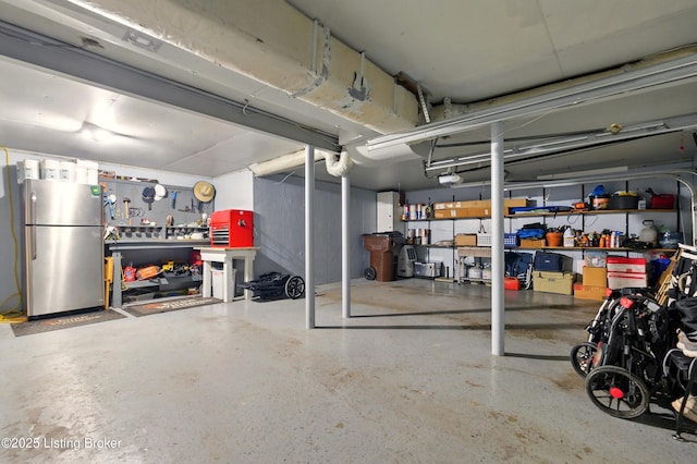 828 Dorsey Ln, Louisville, KY 40223 - garage featuring freestanding refrigerator, a garage door opener, and a workshop area