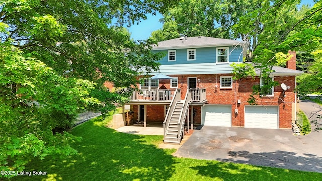 828 Dorsey Ln, Louisville, KY 40223 - back of house featuring stairway, asphalt driveway, a garage, a lawn, and a deck