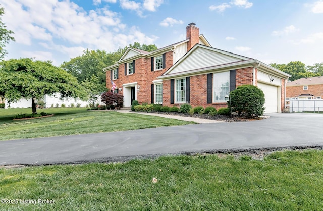1311 Pollitt Ct, Louisville, KY 40223 - colonial inspired home featuring brick siding, a chimney, driveway, a front yard, and a garage