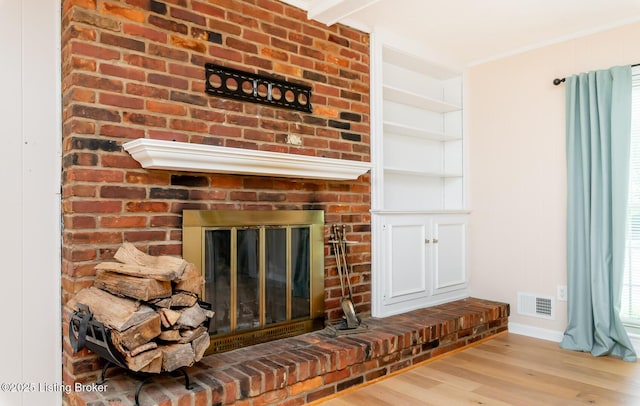 1311 Pollitt Ct, Louisville, KY 40223 - detailed view of wood finished floors, a fireplace, baseboards, and crown molding
