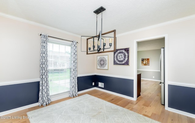 1311 Pollitt Ct, Louisville, KY 40223 - dining space featuring a chandelier, light wood-style flooring, crown molding, baseboards, and a textured ceiling