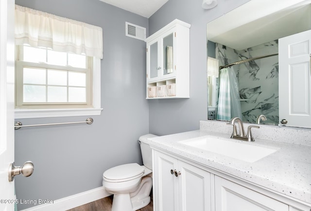 1311 Pollitt Ct, Louisville, KY 40223 - bathroom featuring vanity, curtained shower, toilet, wood finished floors, and baseboards