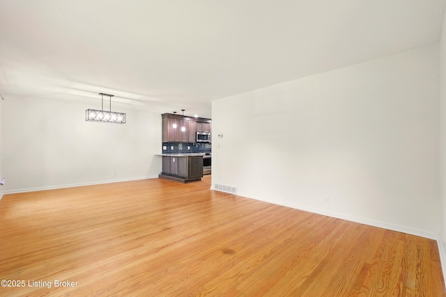 9809 Tiverton Way, Louisville, KY 40242 - unfurnished living room with light wood-style flooring and baseboards