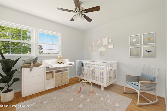 9809 Tiverton Way, Louisville, KY 40242 - bedroom featuring a crib, wood finished floors, baseboards, and ceiling fan