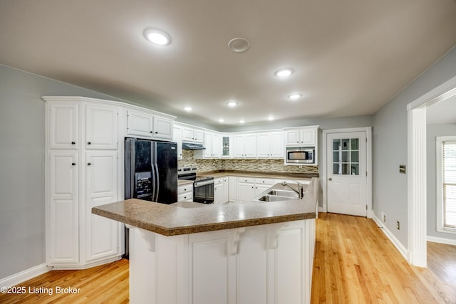 1124 Foxfire Rd, Bardstown, KY 40004 - kitchen with appliances with stainless steel finishes, under cabinet range hood, light wood-style flooring, white cabinetry, and recessed lighting