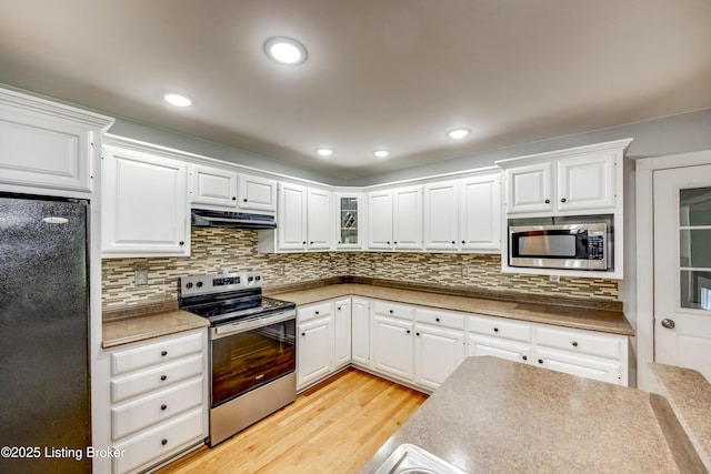 1124 Foxfire Rd, Bardstown, KY 40004 - kitchen featuring stainless steel appliances, under cabinet range hood, light wood-style flooring, white cabinetry, and recessed lighting