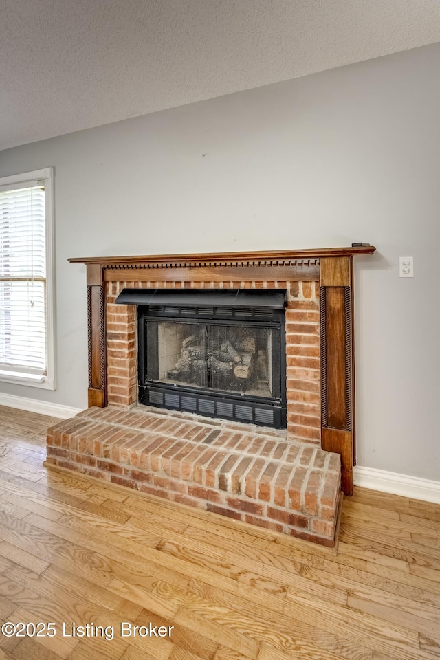 1124 Foxfire Rd, Bardstown, KY 40004 - detailed view of a fireplace, wood finished floors, and a textured ceiling