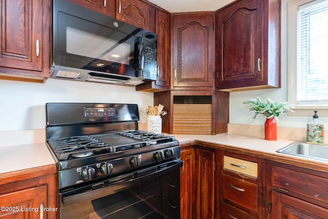 4908 Kay Ave, Louisville, KY 40299 - kitchen with range with gas cooktop, black microwave, and light countertops