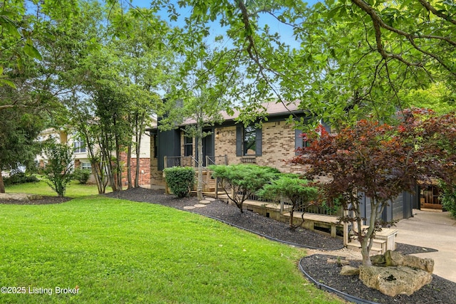 5115 Stony Brook Dr, Louisville, KY 40291 - view of front of house with a front yard, driveway, brick siding, and a garage