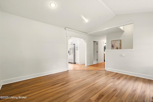 5115 Stony Brook Dr, Louisville, KY 40291 - spare room featuring vaulted ceiling, baseboards, and light wood-type flooring