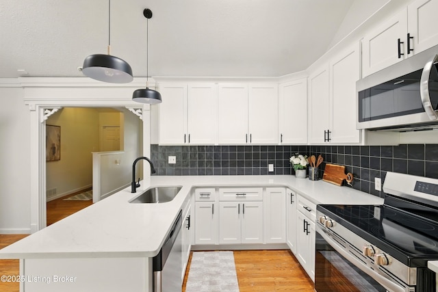 5115 Stony Brook Dr, Louisville, KY 40291 - kitchen featuring appliances with stainless steel finishes, a sink, light wood finished floors, and tasteful backsplash