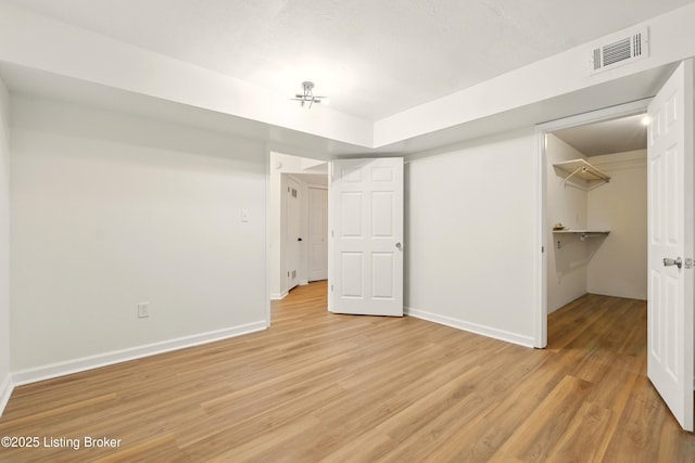5115 Stony Brook Dr, Louisville, KY 40291 - unfurnished bedroom featuring light wood-type flooring, baseboards, a spacious closet, and a closet