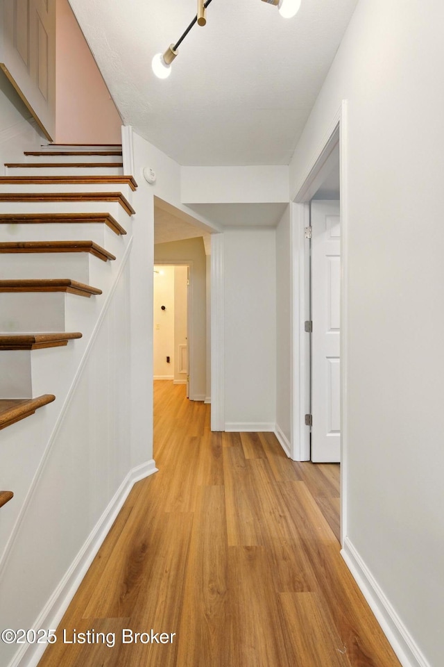 5115 Stony Brook Dr, Louisville, KY 40291 - hallway featuring light wood-style floors, stairway, and baseboards