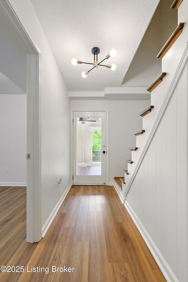 5115 Stony Brook Dr, Louisville, KY 40291 - foyer featuring a chandelier, stairs, wood finished floors, and baseboards