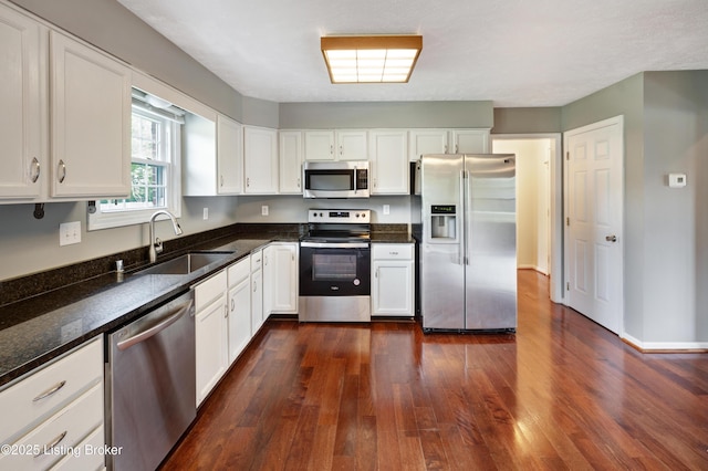 9400 Minute Men Ct, Louisville, KY 40214 - kitchen with stainless steel appliances, a sink, white cabinets, and dark wood finished floors