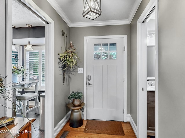 5531 Forest Lake Dr, Prospect, KY 40059 - entryway featuring plenty of natural light, wood finished floors, crown molding, and a chandelier
