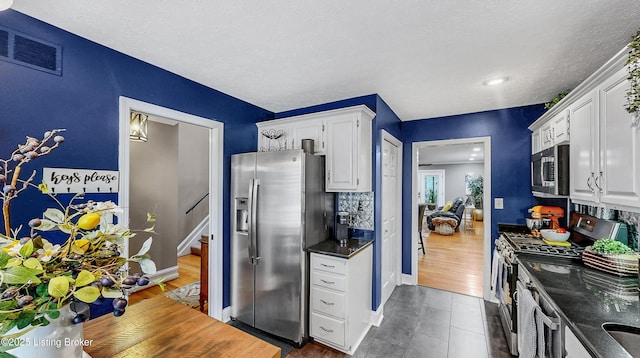 5531 Forest Lake Dr, Prospect, KY 40059 - kitchen featuring stainless steel appliances, white cabinets, tasteful backsplash, recessed lighting, and a textured ceiling