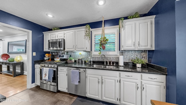 5531 Forest Lake Dr, Prospect, KY 40059 - kitchen featuring stainless steel appliances, white cabinetry, backsplash, a textured ceiling, and dark tile patterned flooring