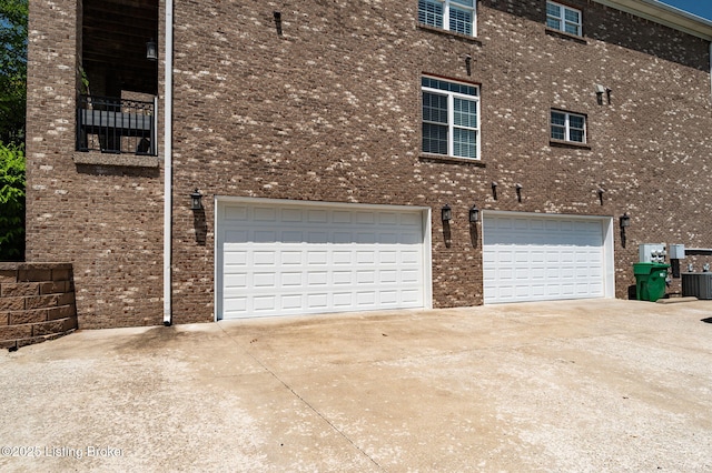 15323 Royal Troon Ave, Louisville, KY 40245 - view of property exterior featuring driveway, a garage, brick siding, and central AC