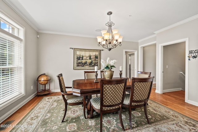 15323 Royal Troon Ave, Louisville, KY 40245 - dining room with a chandelier, crown molding, light wood-style flooring, and baseboards