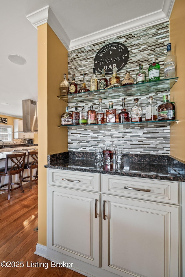 15323 Royal Troon Ave, Louisville, KY 40245 - indoor dry bar with decorative backsplash, wood finished floors, and crown molding