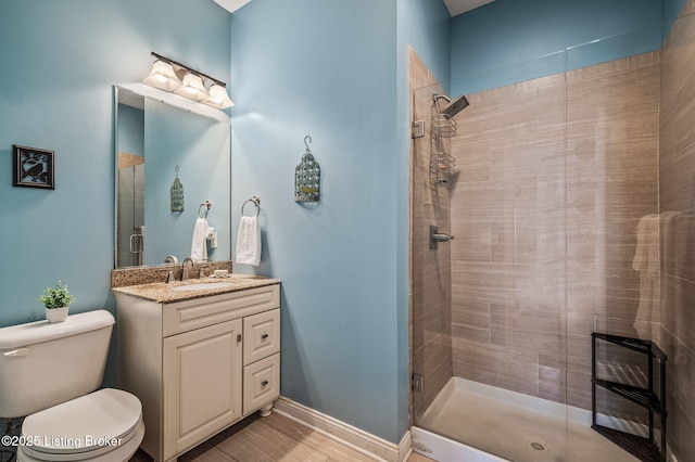 15323 Royal Troon Ave, Louisville, KY 40245 - bathroom featuring vanity, tiled shower, toilet, wood finished floors, and baseboards
