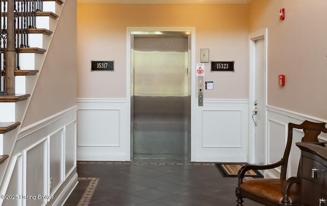 15323 Royal Troon Ave, Louisville, KY 40245 - interior space with elevator, a decorative wall, wainscoting, stairway, and dark tile patterned floors