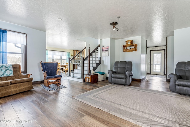 3412 Boyds Knob Rd, Munfordville, KY 42765 - living room featuring wood-type flooring, a textured ceiling, stairway, and baseboards