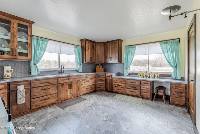 3412 Boyds Knob Rd, Munfordville, KY 42765 - kitchen featuring a sink, tasteful backsplash, healthy amount of natural light, and a textured ceiling