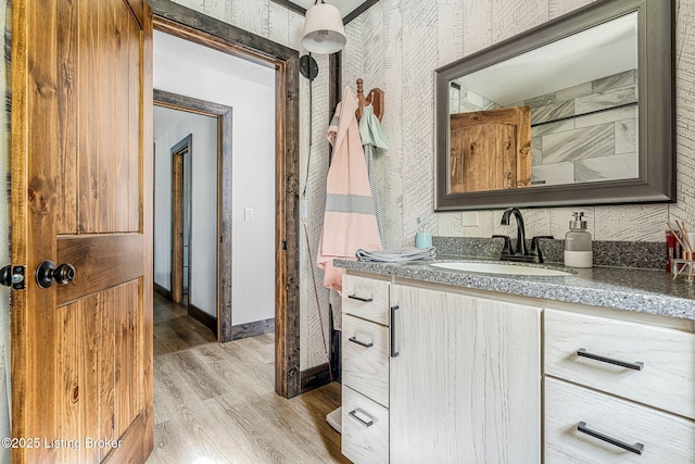 3412 Boyds Knob Rd, Munfordville, KY 42765 - bathroom with vanity, wallpapered walls, wood finished floors, and baseboards
