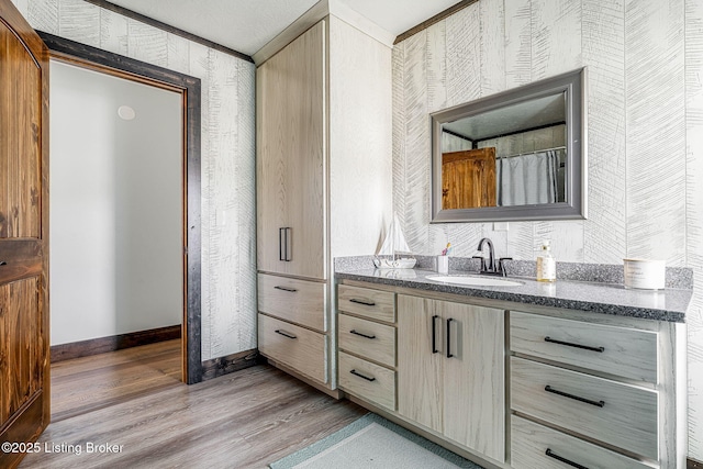 3412 Boyds Knob Rd, Munfordville, KY 42765 - bathroom with wallpapered walls, vanity, wood finished floors, and baseboards
