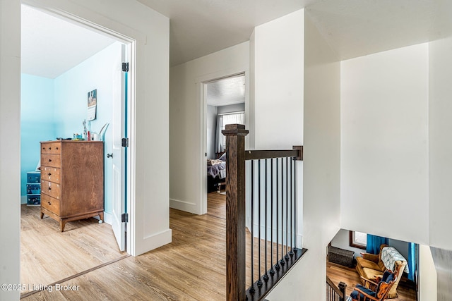 3412 Boyds Knob Rd, Munfordville, KY 42765 - hallway featuring an upstairs landing, wood finished floors, and baseboards