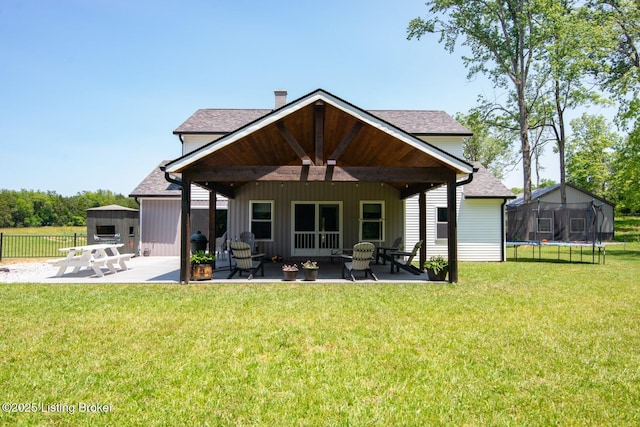 3412 Boyds Knob Rd, Munfordville, KY 42765 - rear view of property featuring a patio area, a trampoline, and a chimney
