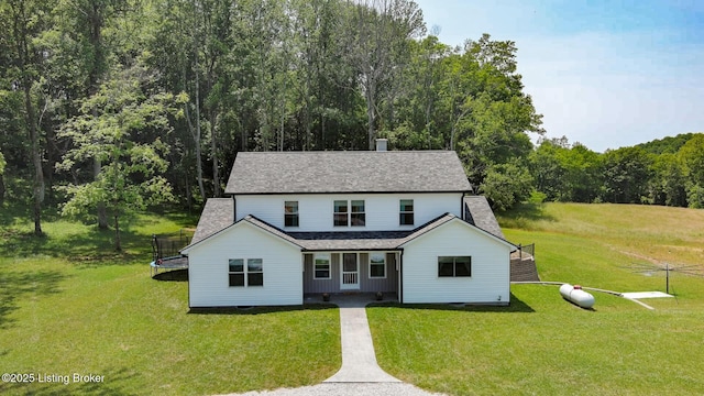 3412 Boyds Knob Rd, Munfordville, KY 42765 - view of front of property featuring a trampoline, a front yard, roof with shingles, and a wooded view
