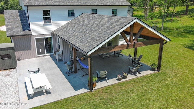 3412 Boyds Knob Rd, Munfordville, KY 42765 - rear view of property with roof with shingles, a lawn, board and batten siding, and a patio area