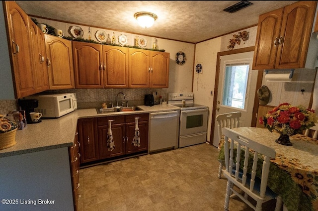 1972 Alice Dr, Lexington, KY 40511 - kitchen with white appliances, a sink, a textured ceiling, brown cabinets, and light flooring